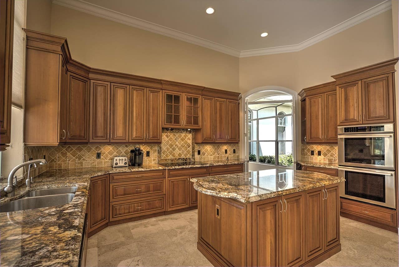 Tile backsplash meeting a stone countertop in a finished kitchen