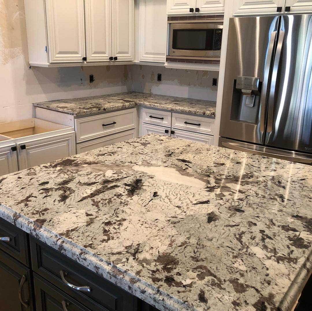 Samples of quartz, quartzite and granite countertop slabs side by side